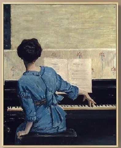 Girl with dark hair sitting at piano one hand on piano one hand behind her 